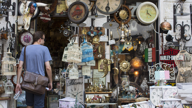 MALCESINE, ITALY - JULY 12: (EDITORIAL USE ONLY) In this handout image provided by Red Bull, a man walks into an antiques and collectables shop prior to the fourth stop of the Red Bull Cliff Diving World Series on July 12, 2013 at Malcesine, Italy. (Photo by Romina Amato/Red Bull via Getty Images)